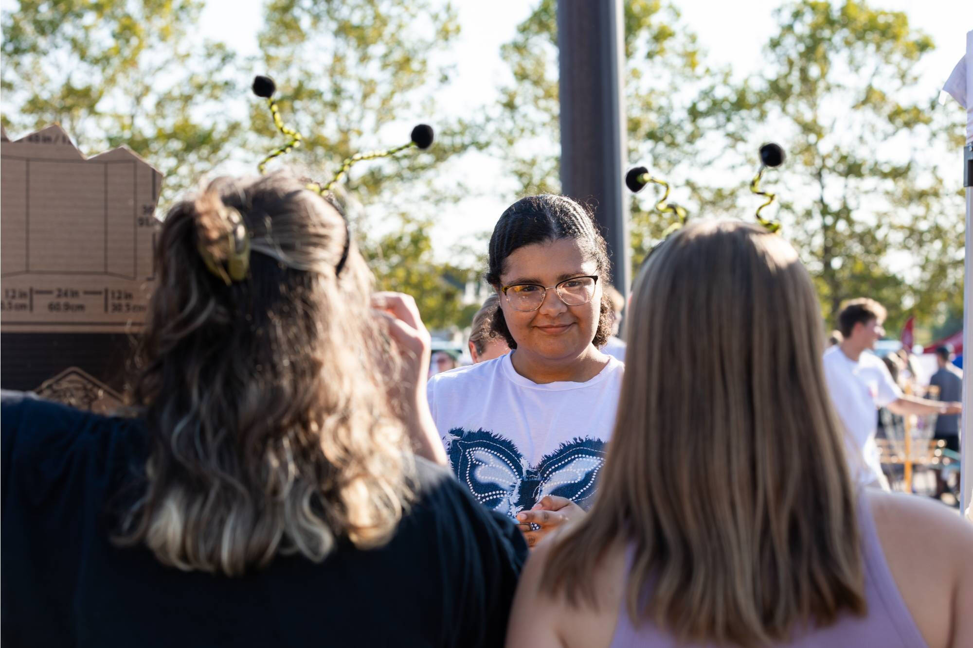 student listening to members of the beekeepers club as they talk about their organization